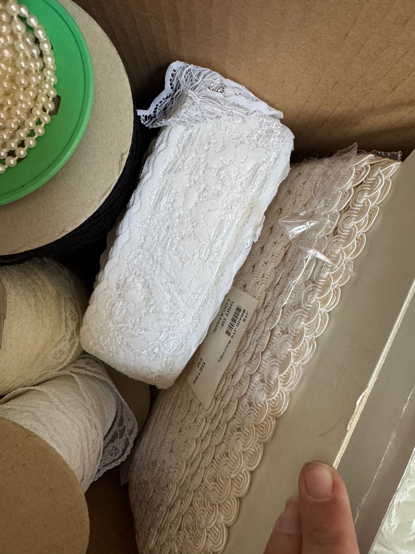Box of trims, lace, pearls & tulle.
