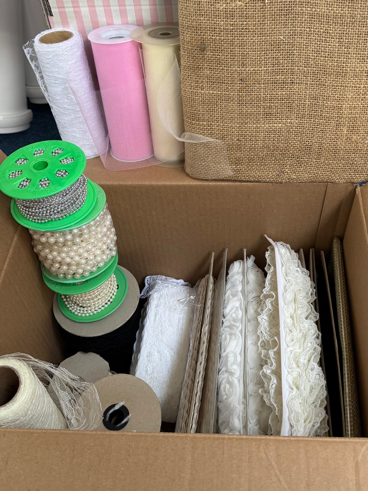 Box of trims, lace, pearls & tulle.