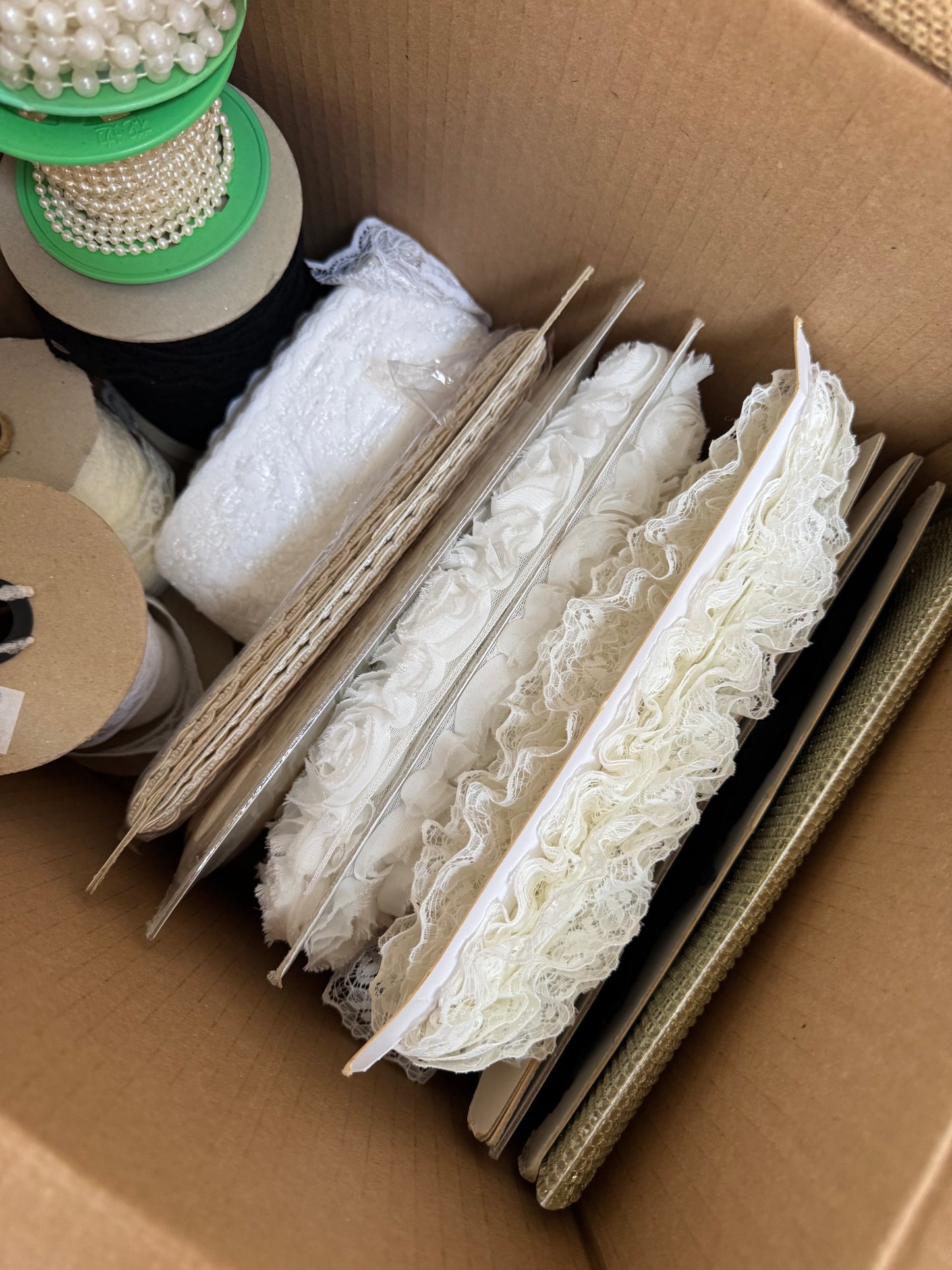 Box of trims, lace, pearls & tulle.