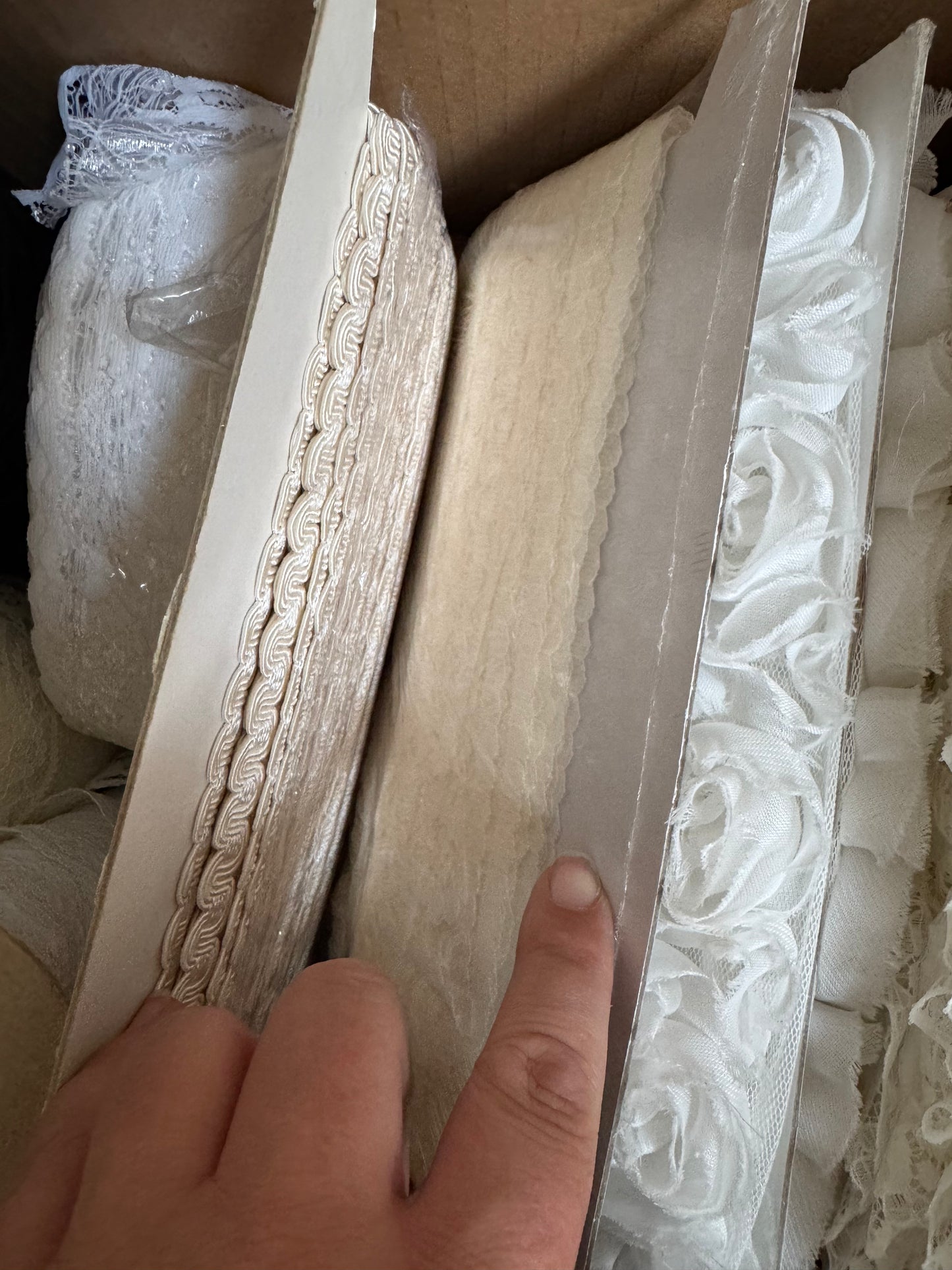 Box of trims, lace, pearls & tulle.